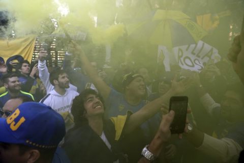 Boca Juniors supporters cheer during a gathering outside the team hotel in Madrid Saturday, Dec. 8, 2018. The Copa Libertadores Final between River Plate and Boca Juniors will be played on Dec. 9 in Madrid, Spain, at Real Madrid's stadium. (AP Photo/Manu Fernandez)