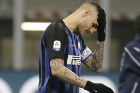 FILE - In this Sunday, Feb. 3, 2019 file photo, Inter Milan's Mauro Icardi walks off the pitch at the end of a Serie A soccer match between Inter Milan and Bologna, at the San Siro stadium in Milan, Italy. Inter is firmly in its mid-season slump and failure to win at Parma on Saturday would deepen the Nerazzurri crisis. The players left the field to deafening jeers from their own fans after Sunday's 1-0 defeat at home to relegation-threatened Bologna to pile more pressure on coach Luciano Spalletti, amid speculation the club is preparing to replace him with Antonio Conte. Inter CEO Giuseppe Marotta has denied Spallettis job is at risk but the clubs grip on a Champions League place is weakening. (AP Photo/Luca Bruno, File)