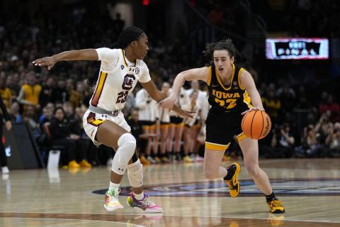 Iowa guard Caitlin Clark (22) drives past South Carolina guard Bree Hall (23) during the first half of the Final Four college basketball championship game in the women's NCAA Tournament, Sunday, April 7, 2024, in Cleveland. (AP Photo/Carolyn Kaster)