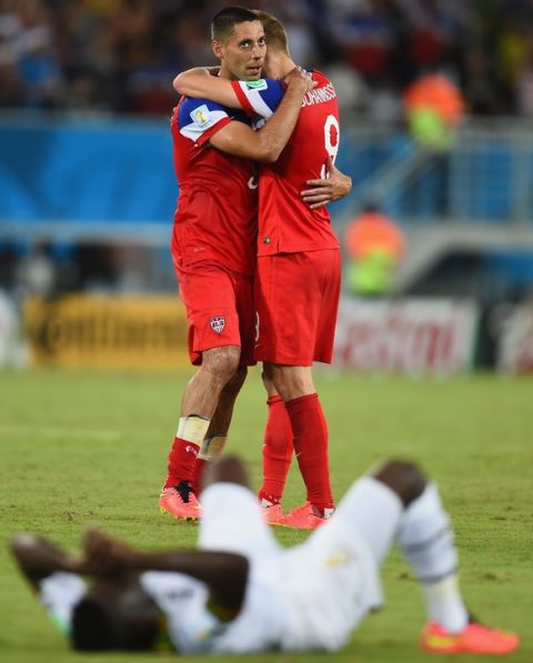 NATAL, BRAZIL - JUNE 16: Clint Dempsey (L) and Aron Johannsson of the United States hug as a Ghana player lies on the ground during the 2014 FIFA World Cup Brazil Group G match between Ghana and the United States at Estadio das Dunas on June 16, 2014 in Natal, Brazil. (Photo by Jamie McDonald/Getty Images)