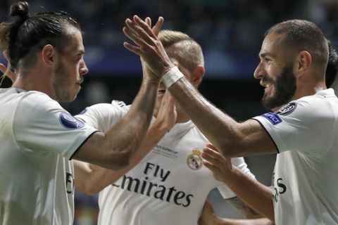 Real Madrid's Gareth Bale, left, and Real Madrid's Karim Benzema celebrate after scoring their side's first goal during the UEFA Super Cup final soccer match between Real Madrid and Atletico Madrid at the Lillekula stadium in Tallinn, Estonia, Wednesday, Aug. 15, 2018. (AP Photo/Mindaugas Kulbis)