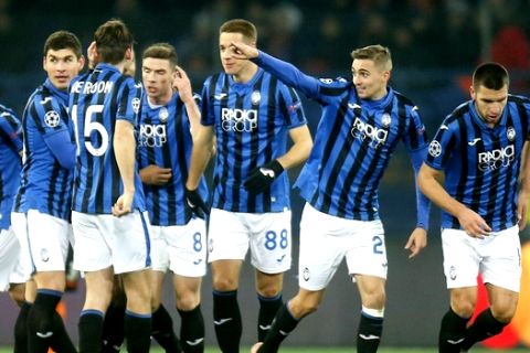 Atalanta's Timothy Castagne, second right, celebrates after scoring his side's opening goal during the Group C Champions League soccer match between FC Shakhtar Donetsk and Atalanta in Kharkiv, Ukraine, Wednesday, Dec. 11, 2019. (AP Photo/Efrem Lukatsky)