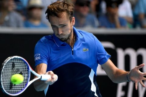 Russia's Daniil Medvedev makes a forehand return to Switzerland's Stan Wawrinka during their fourth round singles match at the Australian Open tennis championship in Melbourne, Australia, Monday, Jan. 27, 2020. (AP Photo/Andy Brownbill)