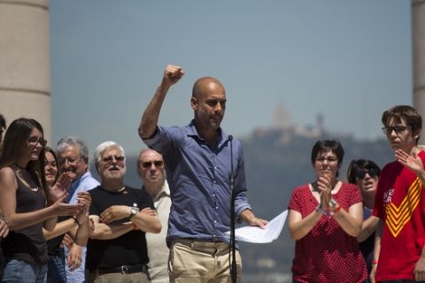 Manchester City coach Pep Guardiola gestures after delivering a speech during a protest organised by the National Assembly for Catalonia, to support the call for referendum in Barcelona, Spain, Sunday, June 11, 2017. On Friday, Catalonia's regional president Carles Puigdemont announced that his government would hold the independence referendum on Oct. 1. Spain's government has promised to not allow the vote on grounds that is unconstitutional since it is matter that would affect all Spaniards. (AP Photo/Emilio Morenatti)