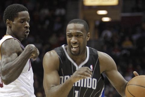 Orlando Magic's Gilbert Arenas (1) drives past Cleveland Cavaliers' Manny Harris (6) in the fourth quarter in an NBA basketball game Monday, March 21, 2011, in Cleveland. The Magic won 97-86. (AP Photo/Tony Dejak)