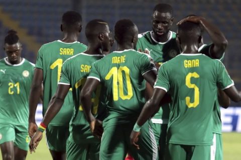 Senegal's Sadio Mane celebrates with teammates after scoring his side's third goal from the penalty spot during the African Cup of Nations group D soccer match between Kenya and Senegal in 30 June Stadium in Cairo, Egypt, Monday, July 1, 2019. (AP Photo/Hassan Ammar)