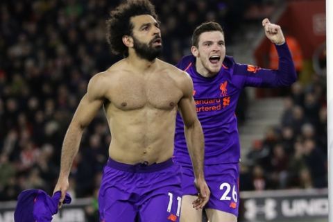Liverpool's Mohamed Salah, left, celebrates after scoring his side's second goal during the English Premier League soccer match between Southampton and Liverpool at St Mary's stadium in Southampton, England Friday, April 5, 2019. (AP Photo/Kirsty Wigglesworth)