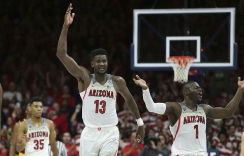 Arizona's Deandre Ayton (13) and Rawle Alkins (1) celebrate during the final seconds of their 84-78 victory over 3rd ranked Arizona State during an NCAA college basketball game, Saturday, Dec. 30, 2017, in Tucson, Ariz. (AP Photo/Ralph Freso)