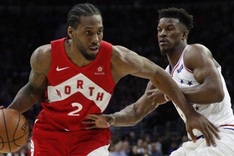 Toronto Raptors' Kawhi Leonard, left, drives against Philadelphia 76ers' Jimmy Butler, right, during the second half of Game 4 of a second-round NBA basketball playoff series, Sunday, May 5, 2019, in Philadelphia. The Raptors won 101-96. (AP Photo/Chris Szagola)