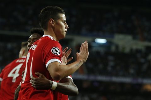 Bayern's James, front, celebrates with teammate David Alaba after scoring his side's second goal during the Champions League semifinal second leg soccer match between Real Madrid and FC Bayern Munich at the Santiago Bernabeu stadium in Madrid, Spain, Tuesday, May 1, 2018. (AP Photo/Paul White)