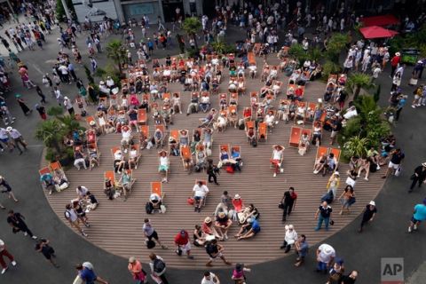 In this Sunday, May 28, 2017 photo, spectators sitting in folding chairs watch a match during the French Open tennis tournament at the Roland Garros stadium in Paris. (AP Photo/Christophe Ena)