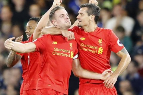 Liverpool's Jordan Henderson celebrates with Dejan Lovren, right, after scoring his side's second goal during the English Premier League soccer match between Chelsea and Liverpool at Stamford Bridge stadium in London, Friday, Sept. 16, 2016. (AP Photo/Frank Augstein)