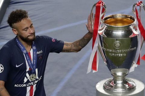 PSG's Neymar touches the trophy after the Champions League final soccer match between Paris Saint-Germain and Bayern Munich at the Luz stadium in Lisbon, Portugal, Sunday, Aug. 23, 2020. (AP Photo/Manu Fernandez, Pool)