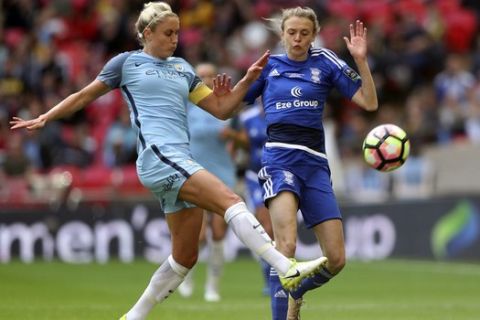 Manchester City's Steph Houghton, left, and Birmingham City's Ellie Brazil battle for the ball during the Women's FA Cup soccer final at Wembley Stadium, London, Saturday May 13, 2017. (Adam Davy/PA via AP)