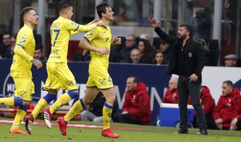 Chievo's Roberto Inglese, third from left, celebrates after scoring his side's second goal during the Serie A soccer match between AC Milan and Chievo Verona at the San Siro stadium in Milan, Italy, Sunday, March 18, 2018. (AP Photo/Antonio Calanni)