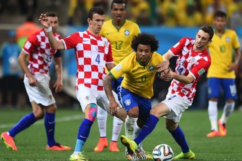 SAO PAULO, BRAZIL - JUNE 12: Marcelo Brozovic of Croatia challenges Marcelo of Brazil during the 2014 FIFA World Cup Brazil Group A match between Brazil and Croatia at Arena de Sao Paulo on June 12, 2014 in Sao Paulo, Brazil.  (Photo by Christopher Lee/Getty Images)