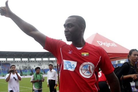 In this Sunday, June 9, 2013 photo, former Manchester United player Andy Cole gives thumbs-up after their charity match against Myanmar Senior National team at Thuwunna stadium in Yangon, Myanmar.(AP Photo)