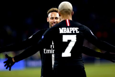 PSG Kylian Mbappe celebrates with teammate Neymar his side's fourth goal during the Champions League group C soccer match between Red Star and Paris Saint Germain, in Belgrade, Serbia, Tuesday, Dec. 11, 2018. (AP Photo/Marko Drobnjakovic)