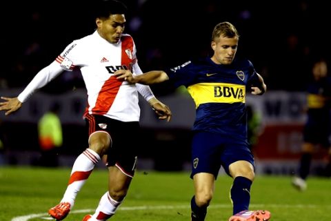 FILE - In this May 7, 2015 file photo, Nicolas Colazo of Boca Juniors, right, fights for the ball with Teofilo Gutierrez of River Plate during a Copa Libertadores soccer match in Buenos Aires, Argentina. (AP Photo/Victor R. Caivano, File)