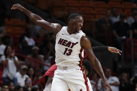 Miami Heat center Bam Adebayo celebrates with a teammate during the third quarter of a preseason NBA basketball game against New Orleans Pelicans in Miami on Wednesday, Oct. 10, 2018. (AP Photo/Brynn Anderson)