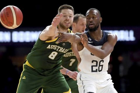 United States' Kemba Walker, right, and Australia's Matthew Dellavedova, left, battle for the ball during their exhibition basketball game in Melbourne, Thursday, Aug. 22, 2019. (AP Photo/Andy Brownbill)