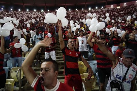 Soccer fans pay homage to the 10 teenaged players who were killed in a fire at the Flamengo training center last Friday, ahead of a soccer match between Flamengo and Fluminense at Maracana Stadium in Rio de Janeiro, Brazil, Thursday, Feb. 14, 2019. Officials have not given an official cause for the blaze, though they have said they are investigating the possibility that an air conditioning unit caught fire after a power surge. (AP Photo/Leo Correa)