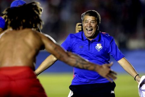 FILE - In this Tuesday, Oct. 10, 2017 filer, Panama's coach Hernan Dario Gomez, from Colombia, celebrates with his player Roman Torres who scored his team's second goal, after a 2018 Russia World Cup qualifying soccer match against Costa Rica in Panama City. (AP Photo/Arnulfo Franco, File)