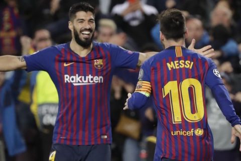 Barcelona's Lionel Messi, right, celebrates with Barcelona's Luis Suarez after scoring his side's second goal during the Champions League semifinal, first leg, soccer match between FC Barcelona and Liverpool at the Camp Nou stadium in Barcelona, Spain, Wednesday, May 1, 2019. (AP Photo/Emilio Morenatti)