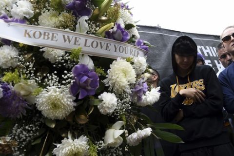 A floral wreath honoring Kobe Bryant appears outside of Staples Center prior to the start of the 62nd annual Grammy Awards on Sunday, Jan. 26, 2020, in Los Angeles. Bryant died Sunday in a helicopter crash near Calabasas, Calif. He was 41. (AP Photo/Chris Pizzello)