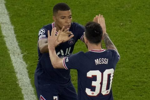PSG's Lionel Messi, right, celebrates with his teammate Kylian Mbappe after scoring his side's third goal during his Champions League soccer match between Paris Saint Germain and RB Leipzig at the Parc des Princes stadium in Paris, Tuesday, Oct. 19, 2021. (AP Photo/Christophe Ena)