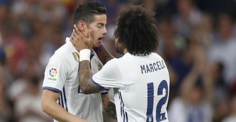 Real Madrid's James Rodriguez, left, celebrates with his teammate Real Madrid's Marcelo after scoring during a Spanish La Liga soccer match between Real Madrid and Barcelona, dubbed 'el clasico', at the Santiago Bernabeu stadium in Madrid, Spain, Sunday, April 23, 2017. (AP Photo/Francisco Seco)