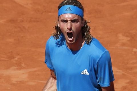 Greece's Stefanos Tsitsipas clenches his fist after scoring a point against Switzerland's Stan Wawrinka during their fourth round match of the French Open tennis tournament at the Roland Garros stadium in Paris, Sunday, June 2, 2019. (AP Photo/Christophe Ena )
