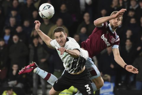 Derby's Craig Forsyth, left, is challenged by West Ham's Tomas Soucek during the English FA Cup 4th round soccer match between Derby County and West Ham at Pride Park stadium in Derby, England, Monday, Jan. 30, 2023. (AP Photo/Rui Vieira)