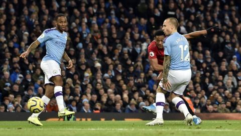 Manchester United's Anthony Martial, second right, scores his side's second goal during the English Premier League soccer match between Manchester City and Manchester United at Etihad stadium in Manchester, England, Saturday, Dec. 7, 2019. (AP Photo/Rui Vieira)