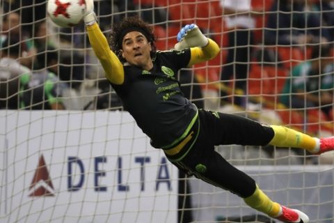 Mexico's Guillermo Ochoa stops a ball during a warmup prior a 2018 Russia World Cup qualifying soccer match between Mexico and Honduras at Azteca stadium in Mexico City, Thursday, June 8, 2017. (AP Photo/Eduardo Verdugo)