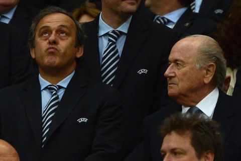 FIFA president Sepp Blatter (R) and UEFA president Michel Platini attend the Euro 2012 football championships semi-final match Germany vs Italy on June 28, 2012 at the National Stadium in Warsaw. Italy won 2-1. AFP PHOTO/ PATRIK STOLLARZ