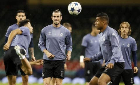 Real Madrid's Gareth Bale, center, watches the ball during a training session at the Millennium stadium in Cardiff, Wales Friday June 2, 2017. Real Madrid will play Juventus in the final of the Champions League soccer match in Cardiff on Saturday. (AP Photo/Kirsty Wigglesworth)