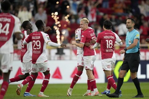 Monaco's Aleksandr Golovin, center, is congratulated by his teammates after scoring his side's second goal from a free kick during the French League One soccer match between AS Monaco and FC Metz, at the Stade Louis II in Monaco, Sunday, Oct. 22, 2023. (AP Photo/Daniel Cole)