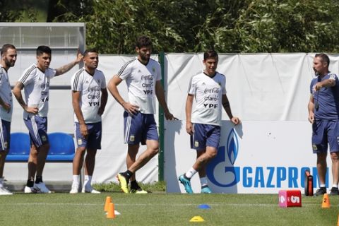 From left to right, Gonzalo Higuain, Enzo Perez, Gabriel Mercado, Federico Fazio and Paulo Dybala listen to a coach assistant during a training session of Argentina at the 2018 soccer World Cup in Bronnitsy, Russia, Sunday, June 17, 2018. (AP Photo/Ricardo Mazalan)