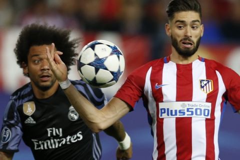 Atletico Madrid's Yannick Carrasco, right, and Real Madrid's Marcelo go for the ball during the Champions League semifinal second leg soccer match between Atletico Madrid and Real Madrid at the Vicente Calderon stadium in Madrid, Wednesday, May 10, 2017. (AP Photo/Francisco Seco)