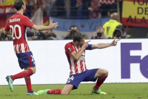 Atletico's Gabi, right, celebrates scoring his side's 3rd goal with his teammate Juanfran during the Europa League Final soccer match between Marseille and Atletico Madrid at the Stade de Lyon in Decines, outside Lyon, France, Wednesday, May 16, 2018. (AP Photo/Laurent Cipriani)