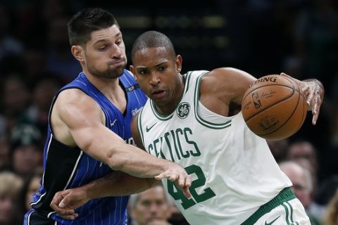Orlando Magic's Nikola Vucevic, left, defends against Boston Celtics' Al Horford (42) during the second half of an NBA basketball game in Boston, Monday, Oct. 22, 2018. (AP Photo/Michael Dwyer)