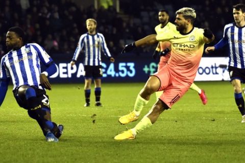 Manchester City's Sergio Aguero, second right, scores his side's opening goal during the FA Cup fifth round soccer match between Sheffield Wednesday and Manchester City at Hillsborough in Sheffield, England, Wednesday, March 4, 2020. (AP Photo/Rui Vieira)