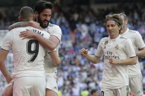 Real Madrid's Isco second from left, celebrates with his teammate Karim Benzema after scoring during a Spanish La Liga soccer match between Real Madrid and Celta at the Santiago Bernabeu stadium in Madrid, Spain, Saturday, March 16, 2019.(AP Photo/Paul White)