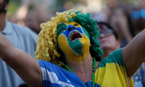 A Brazil soccer fan looks up to heaven as her team is down by two goals at halftime, as she watches a live telecast of the Brazil vs. Belgium World Cup quarter finals soccer match, in Rio de Janeiro, Brazil, Friday, July 6, 2018. (AP Photo/Silvia Izquierdo)