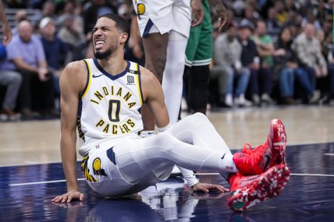 Indiana Pacers guard Tyrese Haliburton (0) reacts after being injured during the first half of an NBA basketball game against the Boston Celtics in Indianapolis, Monday, Jan. 8, 2024. (AP Photo/Michael Conroy)