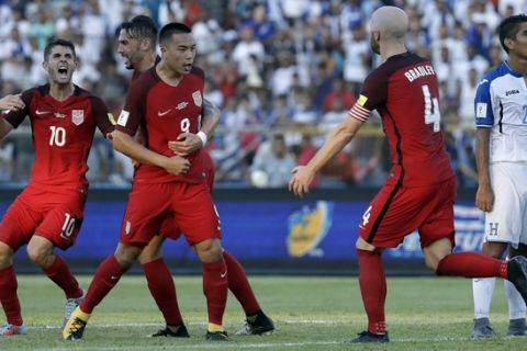 United States' Bobby Wood, 9, celebrates with teammates after scoring his team's first goal during a 2018 World Cup qualifying soccer match against Honduras in San Pedro Sula, Honduras, Tuesday, Sept. 5, 2017. (AP Photo/Rebecca Blackwell)