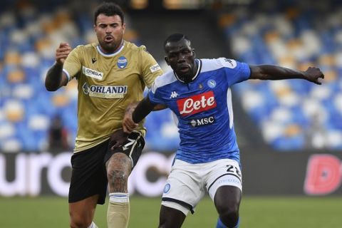 Napoli's Kalidou Koulibaly, right, competes for the ball with SPAL's Andrea Petagna during the Serie A soccer match between Napoli and SPAL, at the San Paolo Stadium in Naples, Italy, Sunday, June 28, 2020. (Cafaro/LaPresse via AP)