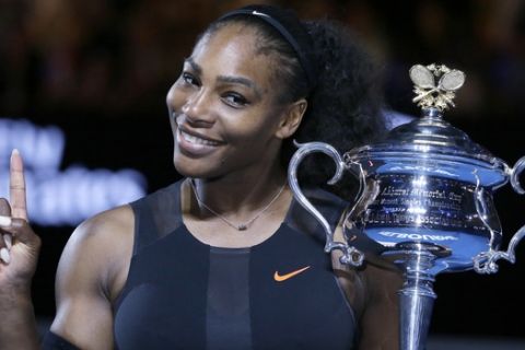 FILE - In this Jan. 28, 2017, file photo, Serena Williams holds up a finger and her trophy after defeating her sister, Venus, in the women's singles final at the Australian Open tennis championships in Melbourne, Australia. A spokeswoman for Williams says the tennis star is pregnant. Kelly Bush Novak wrote in an email to The Associated Press on Wednesday, April 19, 2017: "I'm happy to confirm Serena is expecting a baby this Fall."  Earlier in the day, Williams posted a photo of herself on the social media site Snapchat with the caption "20 weeks." (AP Photo/Aaron Favila, File)