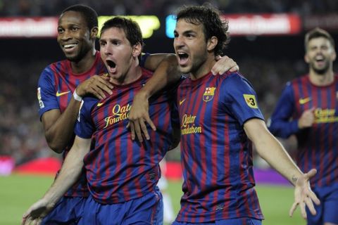 Barcelona's Argentinian forward Lionel Messi (C) is congratulated by his teammates Barcelona's midfielder Cesc Fabregas (R) and Barcelona's Malian midfielder Seydou Keita (L) after scoring during the second leg of the Spanish Supercup football match FC Barcelona vs Real Madrid CF on August 17, 2011 at the Camp Nou stadium in Barcelona. Barcelona won the Spanish Supercup 3-2.     AFP PHOTO/ JOSEP LAGO (Photo credit should read JOSEP LAGO/AFP/Getty Images)